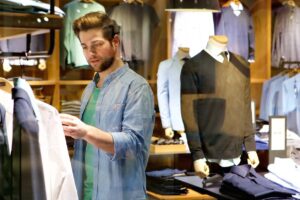 man looks at tag while shopping